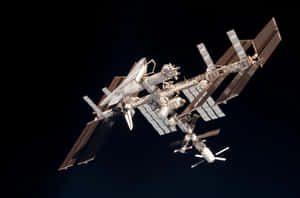 Awe-inspiring View Of The International Space Station Against The Backdrop Of Earth Wallpaper