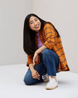 Awkwafina Radiates In Orange Checkered Polo Wallpaper