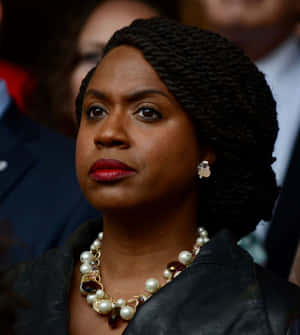 Ayanna Pressley In A Serious Pose Dressed In Black. Wallpaper