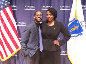 Ayanna Pressley Smiling With Smiling Man Wallpaper