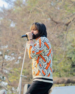 Babbu Maan Singing Passionately Onstage Wallpaper