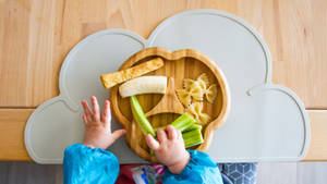 Baby Hands With Plate Of Food Wallpaper