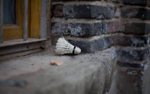 Badminton Shuttlecock On A Window Ledge Wallpaper