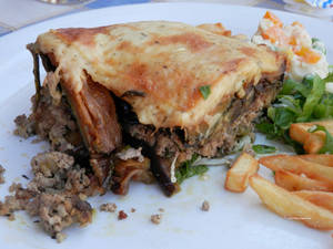 Baked Moussaka With Fries On A Plate Wallpaper