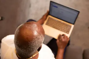 Bald Man Using Laptop Wallpaper