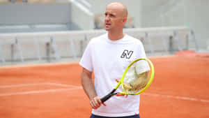 Bald Tennis Coach On Clay Court Wallpaper