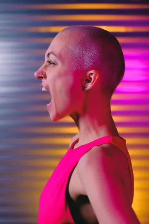 Bald Woman Laughing Against Colorful Background Wallpaper