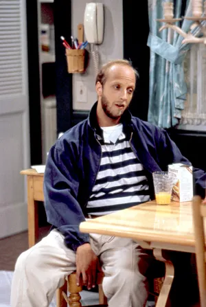 Balding Man Sittingat Kitchen Table Wallpaper