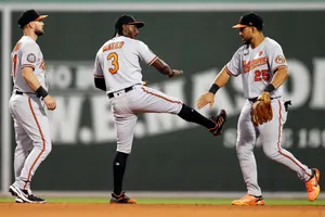 Baltimore Orioles Players Celebrating On Field Wallpaper