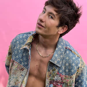 Barry Keoghan Stylish Pose Pink Background Wallpaper