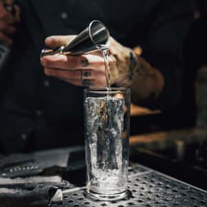 Bartender Pouring Drink Into Glass Wallpaper
