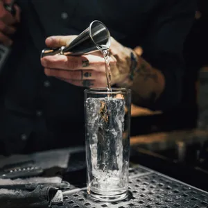 Bartender Pouring Drink Into Glass Wallpaper