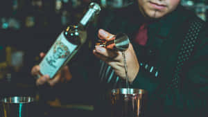 Bartender Pouring Spirit Into Jigger Wallpaper