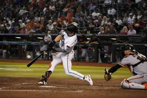 Baseball Batter Swingingat Pitch Wallpaper