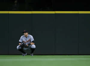 Baseball Player Crouchingon Field Wallpaper