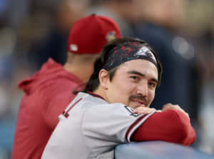 Baseball Player Smiling Dugout Moment Wallpaper