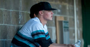 Baseball Player Watching Game From Dugout Wallpaper