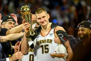 Basketball Champion Holding Trophy Wallpaper