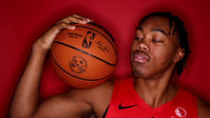 Basketball Player Contemplative Posewith Ball Wallpaper