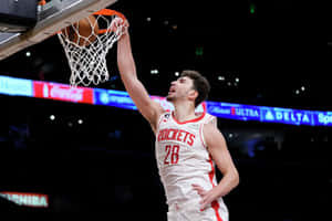 Basketball Player Dunking During Game Wallpaper