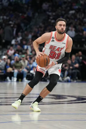 Basketball Player In Action Miami Heat Uniform Wallpaper