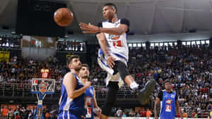 Basketball_ Player_ Mid Air_ Pass_ At_ Game Wallpaper