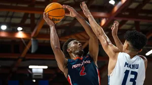 Basketball Player Shooting Over Defender Wallpaper