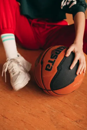 Basketball Player Sittingwith Ball.jpg Wallpaper