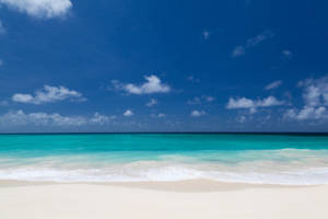 Basking In The Serenity Of The White Beach Wallpaper