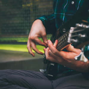 Bass Guitarist Fingering Technique Wallpaper