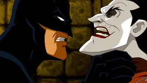 Batman Confronting Red Hood - Intense Face-off Wallpaper