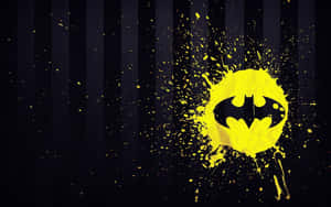 Batman Logo On A Black Background With Yellow Paint Splatters Wallpaper