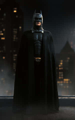 Batman Standing Tall Amidst The Darkness Wallpaper