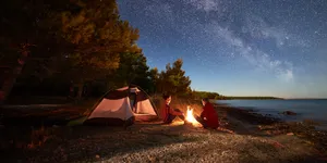 Beach Camping Under A Starlit Sky Wallpaper