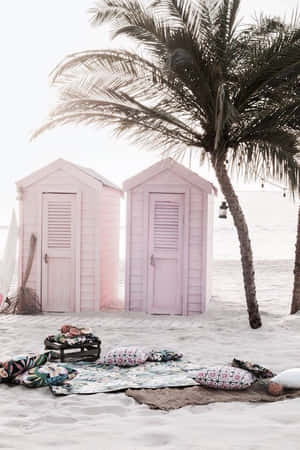Beautiful Beach Huts Lined Up On A Sandy Shore Wallpaper