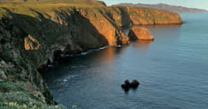 Beautiful California Island With Pristine Beaches And Lush Green Mountains In The Sunset. Wallpaper