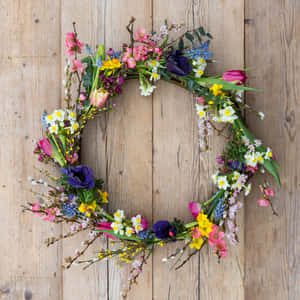 Beautiful, Colorful Spring Wreath On A Wooden Door Wallpaper