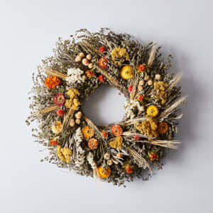 Beautiful Fall Wreath Hanging On A Wooden Door Wallpaper