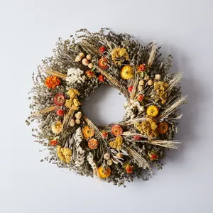 Beautiful Fall Wreath Hanging On A Wooden Door Wallpaper
