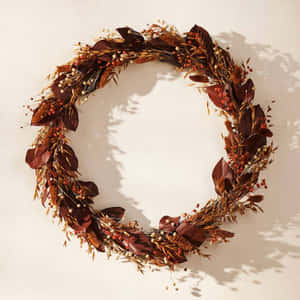 Beautiful Fall Wreath On A Rustic Wooden Door Wallpaper