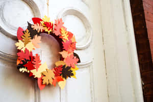Beautiful Fall Wreath On Rustic Wooden Door Wallpaper