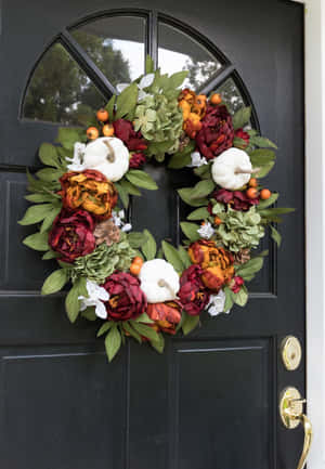 Beautiful Fall Wreath With Colorful Autumn Leaves And Berries On A Rustic Wooden Background Wallpaper