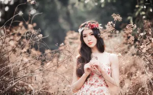 Beautiful Girl Wearing A Vibrant Floral Crown Wallpaper