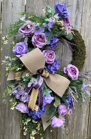 Beautiful Handcrafted Spring Wreath Adorning A Rustic Door Wallpaper