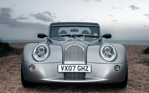 Beautiful Morgan Sports Car Parked By The Picturesque Coast Wallpaper