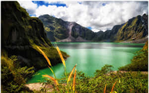 Beautiful Mountain Lake With Emerald Green Waters Wallpaper