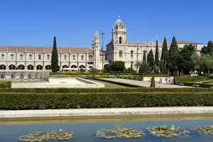 Beautiful Reflection Of Mosteiro Dos Jeronimos In A Serene Pond. Wallpaper