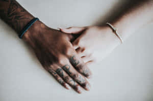 Beautiful Shot Of Two Tangible Hands, A Black And White Hand Holding Wallpaper