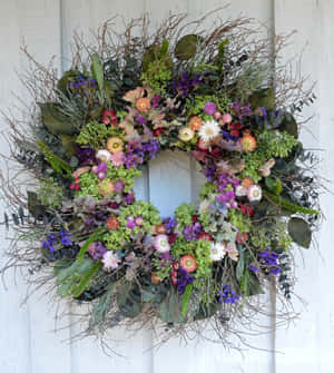 Beautiful Spring Wreath Adorning A Front Door Wallpaper