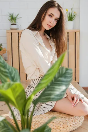 Beige Aesthetic Woman Sitting Indoors Wallpaper